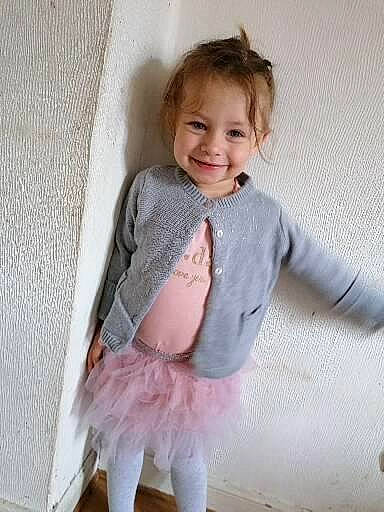 Emy a rejoint le concours — aidez-le/la à gagner de superbes lots ! baby, baby_toddler_clothing, ballet_tutu, collar, day_dress, dress, embellishment, happy, iris, joy, magenta, outerwear, pattern, person, ruffle, skin, sleeve, smile, sock, textile