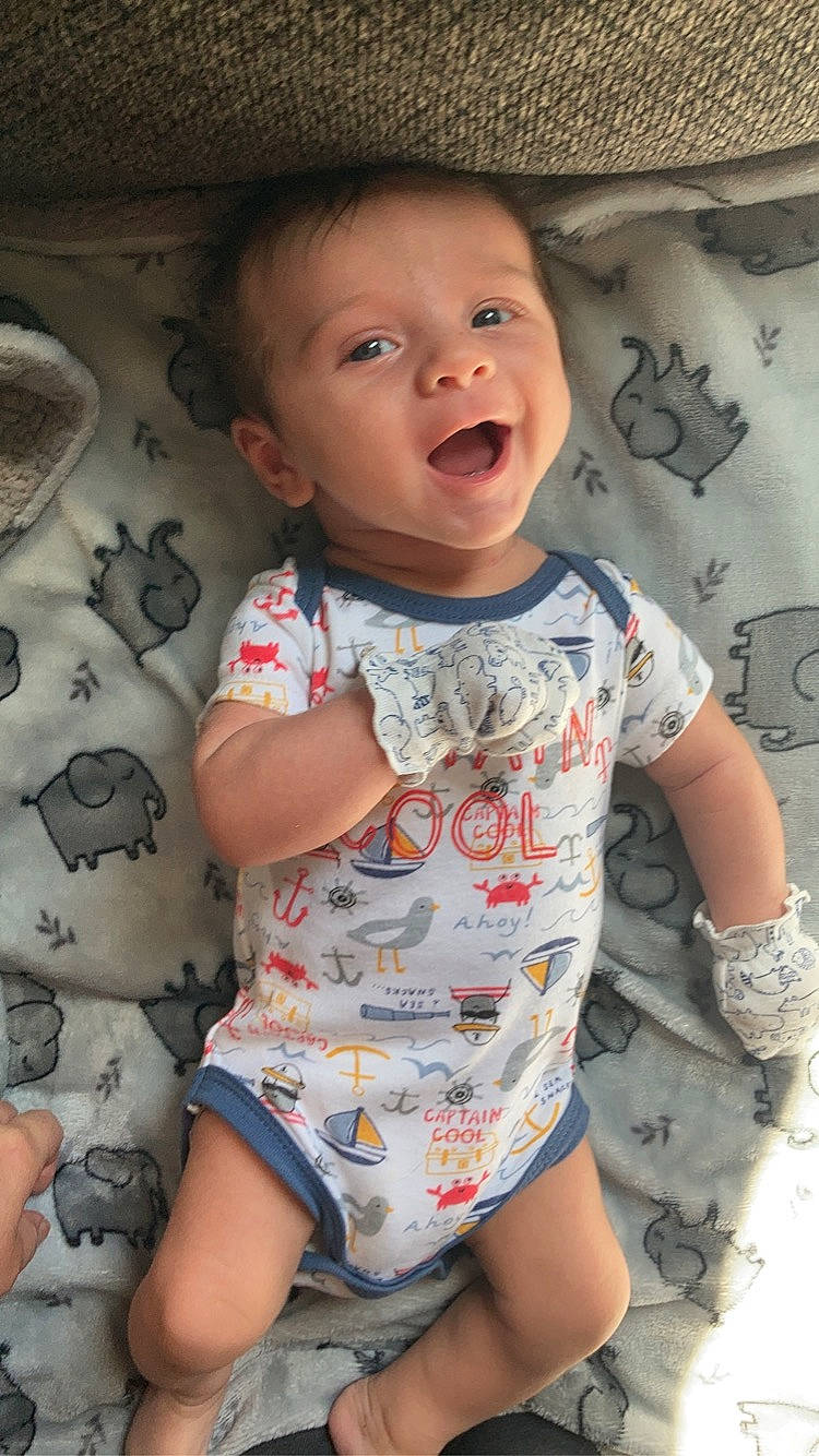 Silas is registered to the contest to win money with this photo: arm, baby_toddler_clothing, cheek, chin, facial_expression, hairstyle, human, human_body, lip, mouth, neck, nose, organ, person, photograph, product, skin, sleeve, smile, textile