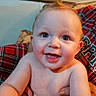 baby, infant, child, smiling, happy, portrait, sitting, indoors, plaid, blanket, arms, adult, hands, blue_eyes, gummy_smile, hair, diaper, close_up, family, cozy