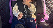 Halle joined the competition — help win amazing prizes! child, toddler, car_seat, graco, smiling, clothing, sweatshirt, pants, shoe, car_interior, seat_belt, quilted_leather, window, sunlight, hair, face, playful, cute, seat, sitting