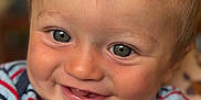 Luca is registered to the contest to win money with this photo: baby, child, face, smile, eyes, tooth, sweater, striped, closeup, portrait, happy, cute, infant, skin, hair, cheek, person, indoors, warm, expression