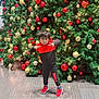 Fateh joined the competition — help win amazing prizes! child, christmas_tree, ornaments, red, gold, holiday, festive, pose, playful, indoor, floor, tiles, sneakers, clothing, person, celebration, decorations, greenery, lights, young