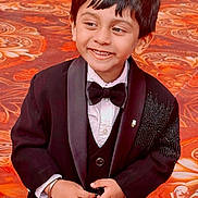 Fateh joined the competition — help win amazing prizes! child, boy, tuxedo, bow_tie, smile, black_jacket, formal_wear, hands, carpet, patterned_floor, portrait, short_hair, button, indoor, cute, happy, person, fashion, celebration, young