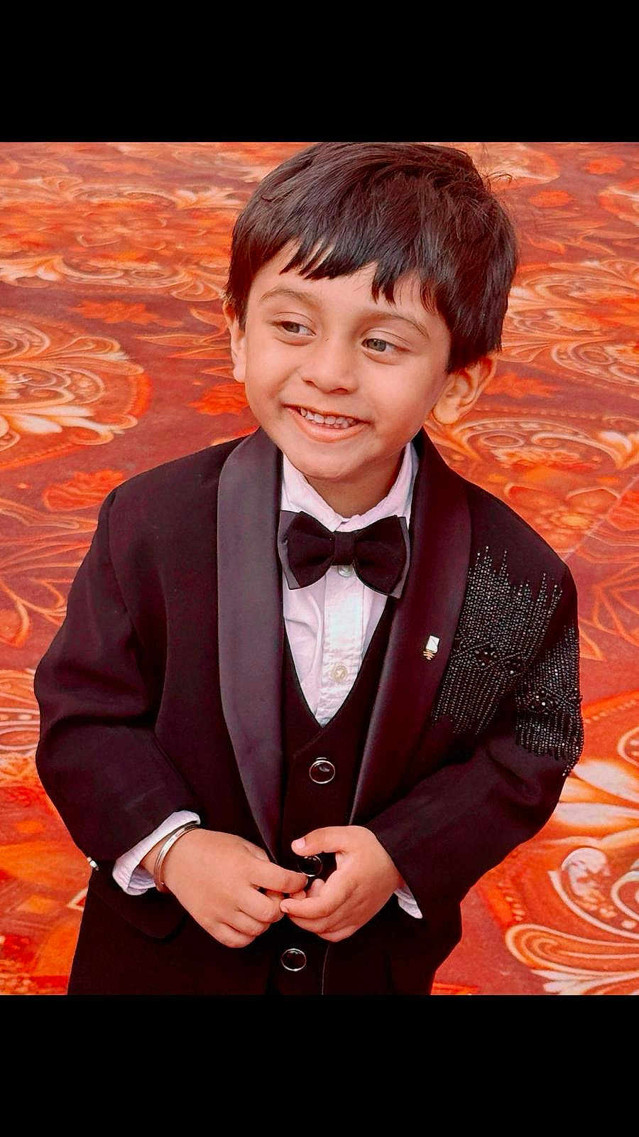 Fateh joined the competition — help win amazing prizes! child, boy, tuxedo, bow_tie, smile, black_jacket, formal_wear, hands, carpet, patterned_floor, portrait, short_hair, button, indoor, cute, happy, person, fashion, celebration, young