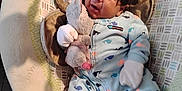 Izaiah joined the competition — help win amazing prizes! baby, baby_seat, carpet, child, clothing, comfort, cozy, cute, expression, face, handwear, indoor, infant, lying_down, mobile, newborn, onesie, plush_toy, soft_toys, whale_pattern