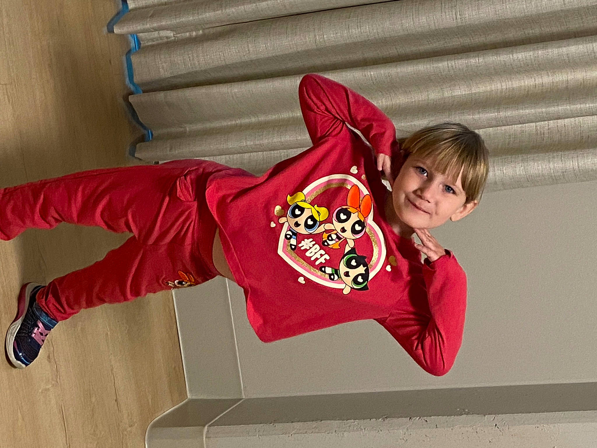 Emily is registered to the contest to win money with this photo: carmine, child, elbow, flooring, font, fun, happy, human_leg, jersey, joy, leisure, logo, pajamas, person, sleeve, smile, sportswear, t_shirt, thigh, toddler