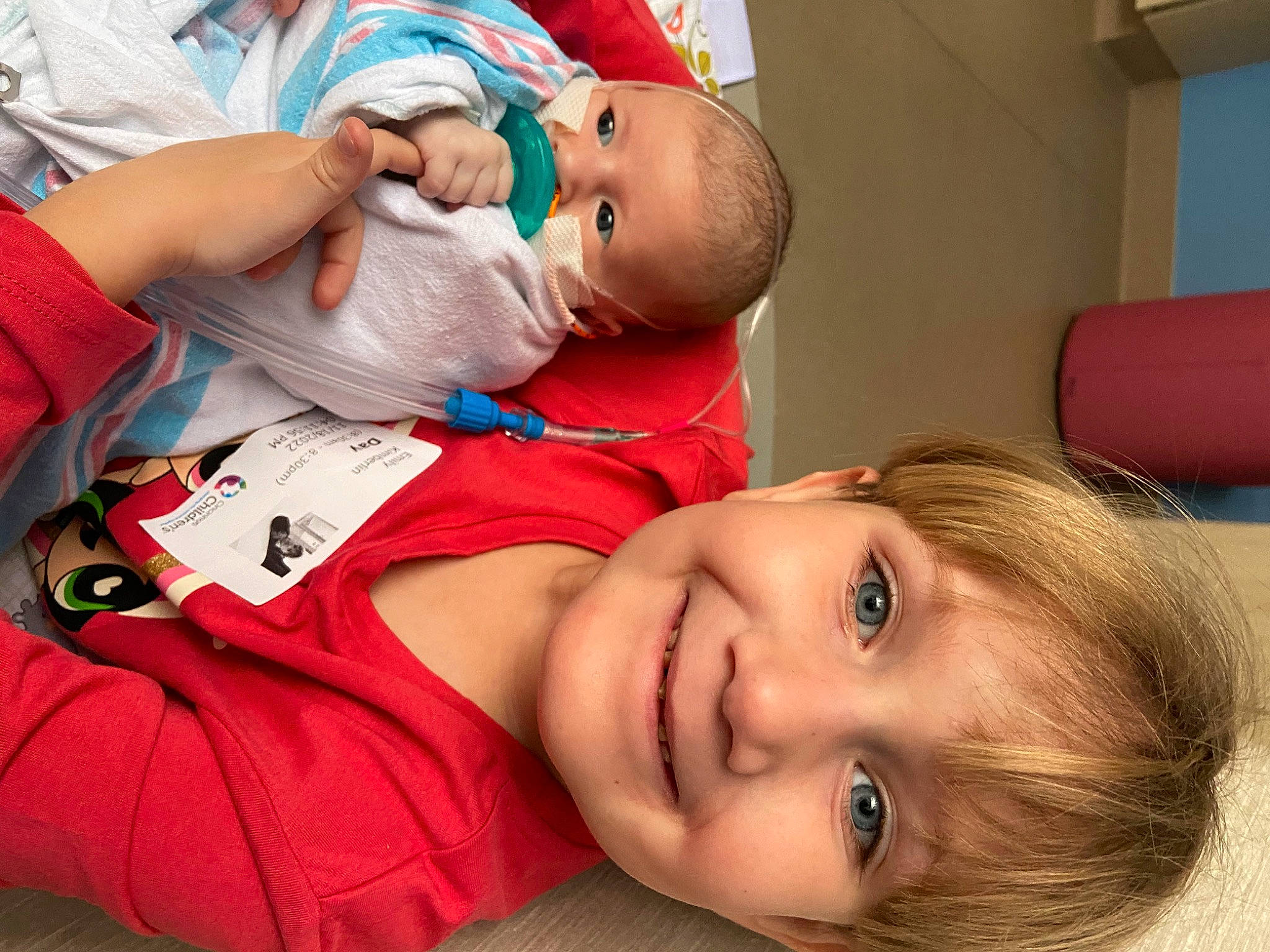 Emily is registered to the contest to win money with this photo: baby, baby_toddler_clothing, cheek, child, comfort, event, eyelash, fun, happy, hat, joy, mouth, nose, person, portrait_photography, red, room, service, skin, smile