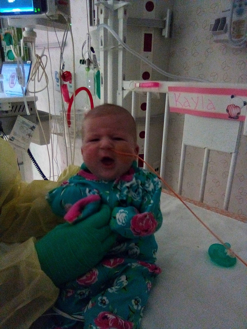 Kayla is registered to the contest to win money with this photo: baby, baby_toddler_clothing, baby_toys, cheek, child, comfort, flooring, fun, person, play, room, sitting, smile, television, toddler, wood