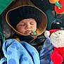 Mazen is registered to the contest to win money with this photo: baby, sleeping, hoodie, knit_hat, blanket, plush_toy, santa_claus, car_seat, child, cozy, winter_clothing, peaceful, infant, toy, wrapped, cute, face, bundle, resting, comfort