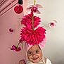 Jazmin joined the competition — help win amazing prizes! baby, child, smiling, pink, headwrap, flowers, hanging_flowers, indoor, wall, decor, cute, portrait, person, young_child, happy, floral, colorful, playful, bright, closeup