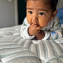 Jesús joined the competition — help win amazing prizes! baby, infant, child, face, hand, fingers, mattress, texture, bedroom, closeup, portrait, curious, lying_down, sleepwear, soft_focus, indoor, cute, skin, expression, young