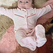 Zélie participe au concours pour gagner de l'argent avec cette photo : baby, infant, newborn, onesie, pink_clothing, blanket, fur_rug, plush, face, eyes, hair, socks, arms_outstretched, legs, lying_down, cozy, cute, pet, paw, looking_up