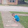 art, barefoot, blue_shirt, boy, chalk, child, concrete, creative, crouching, curly_hair, daytime, drawing, grass, house, outdoor, play, quiet, residential, sidewalk, young
