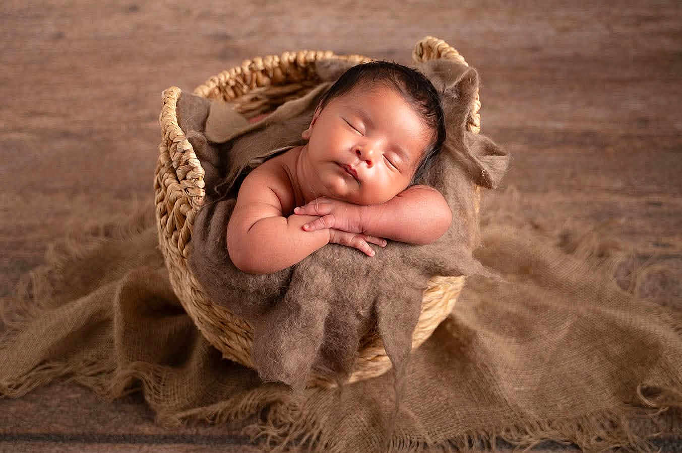 Jason is registered to the contest to win money with this photo: baby, sleeping, basket, brown, fabric, cozy, infant, peaceful, soft, hands, rest, wooden_floor, cute, portrait, newborn, child, wrapped, relaxed, indoors, warm_lighting