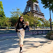 Sofia joined the competition — help win amazing prizes! woman, child, eiffel_tower, street, trees, sunlight, shadows, sunglasses, scarf, hat, sidewalk, car, urban, daytime, fashion, pedestrian, outdoor, person, walking, parked_cars