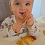toddler, child, food, toast, snack, high_chair, mickey_mouse, pajamas, table, indoor, smiling, face, hands, cute, eating, home, light, window, person, breakfast