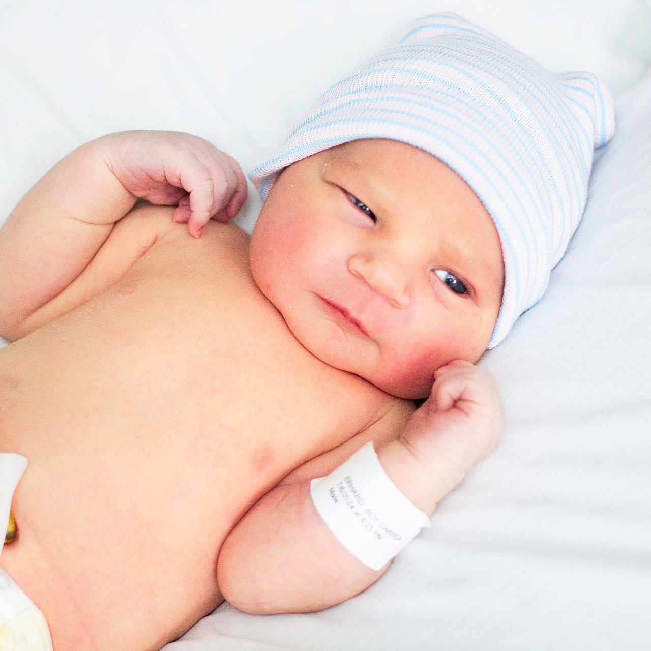 Layne is registered to the contest to win money with this photo: architecture, baby, bed, bodypart, building, clothing, diaper, face, finger, furniture, glove, hand, hat, head, hospital, newborn, person, photography, portrait, sleeping