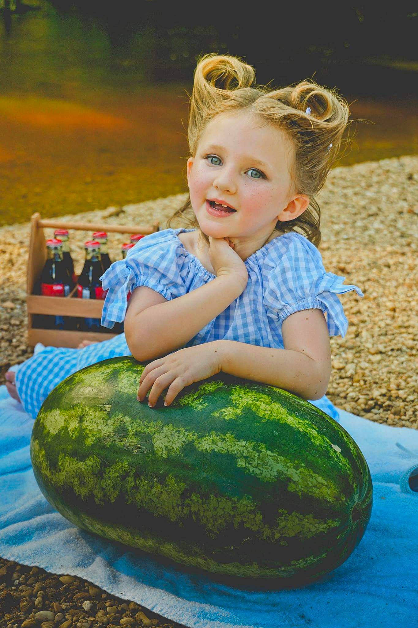 Loralei is registered to the contest to win money with this photo: cucurbita, food, fruit, goggles, grass, green, happy, leisure, melon, natural_foods, people_in_nature, person, photograph, plant, produce, smile, squash, sunglasses, toddler, vegetable