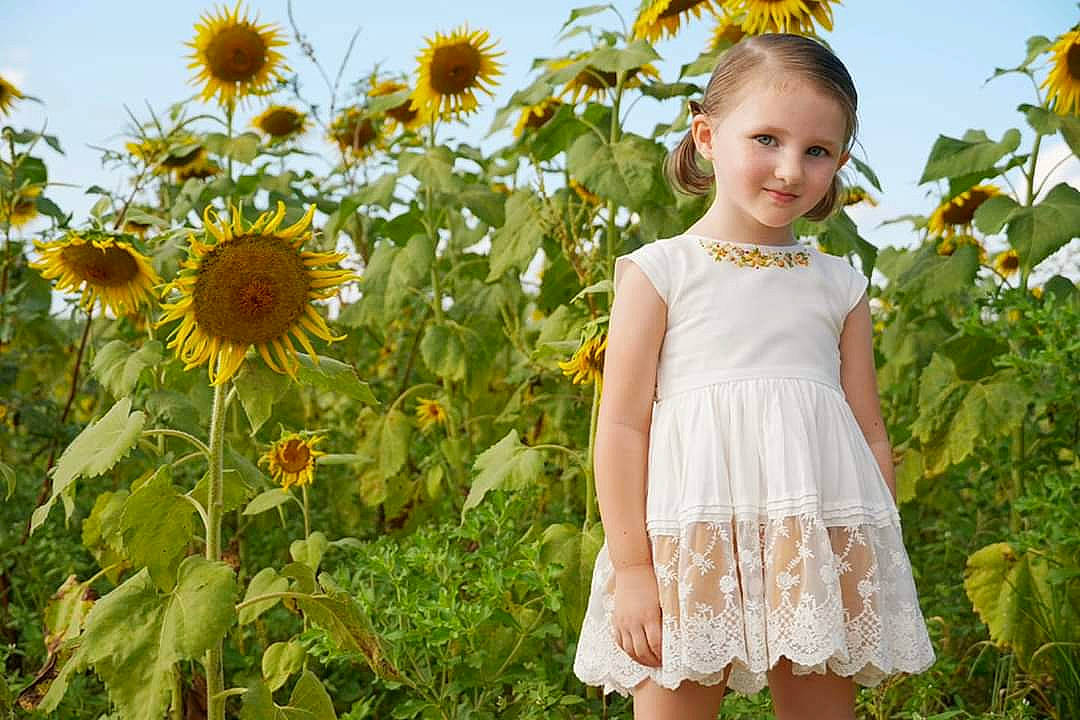 Loralei joined the competition — help win amazing prizes! baby_toddler_clothing, botany, day_dress, dress, face, flower, grass, green, happy, joy, nature, one_piece_garment, people_in_nature, person, petal, plant, sky, sleeve, smile, summer