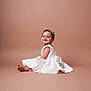 baby, child, smile, white_dress, headband, sitting, portrait, studio, cute, happy, infant, face, girl, elegant, fashion, young, adorable, background, skin, photography