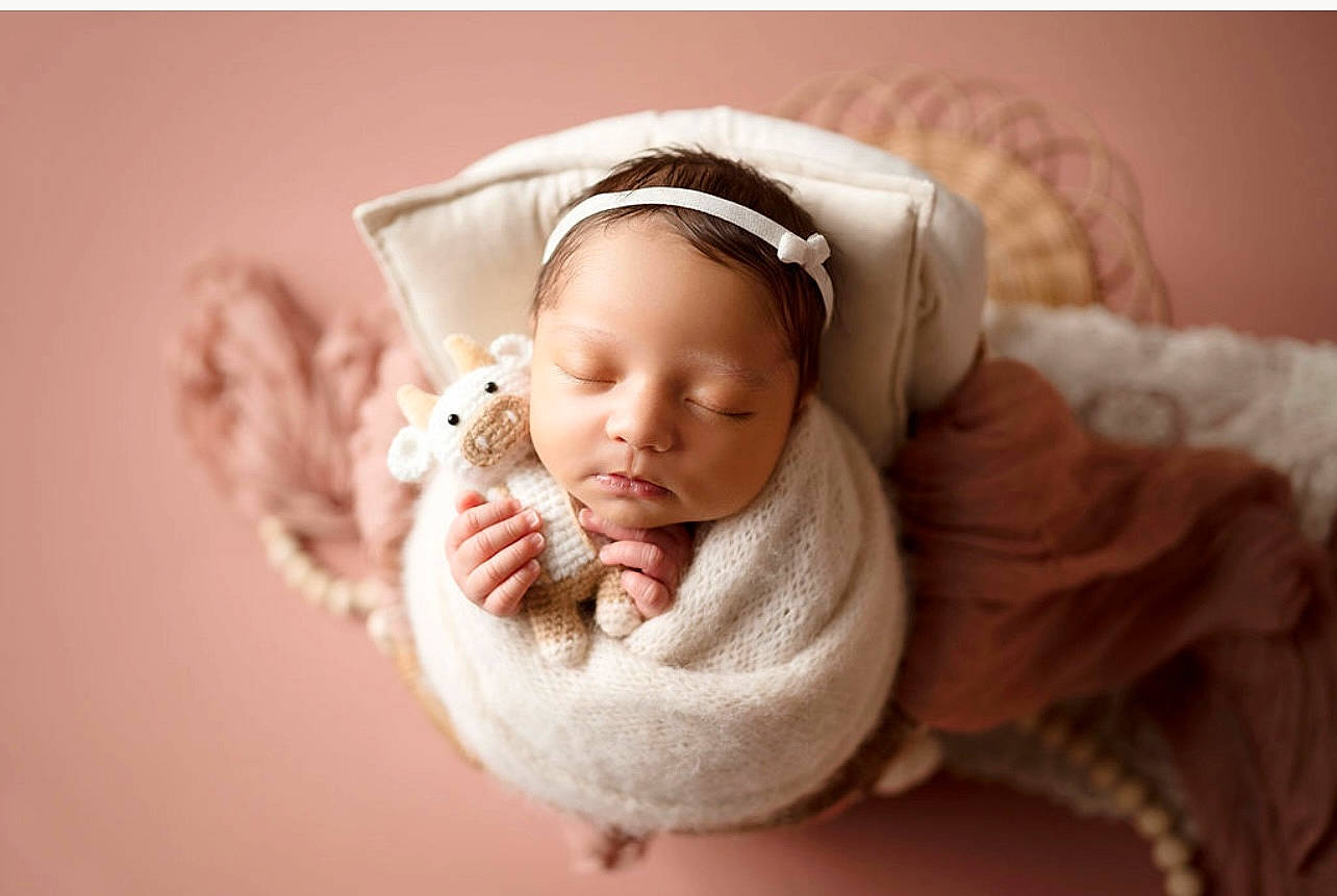Jordyn is registered to the contest to win money with this photo: arm, baby, baby_sleeping, baby_toddler_clothing, cheek, comfort, eye, face, fashion_accessory, fur, happy, headband, headgear, headpiece, headwear, human_body, knit_cap, linens, person, petal