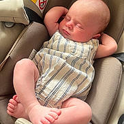 Beau is registered to the contest to win money with this photo: baby, infant, sleeping, car_seat, romper, striped_clothing, peaceful, cute, child, newborn, relaxed, skin, foot, hand, face, head, seatbelt, fabric, indoor, closeup