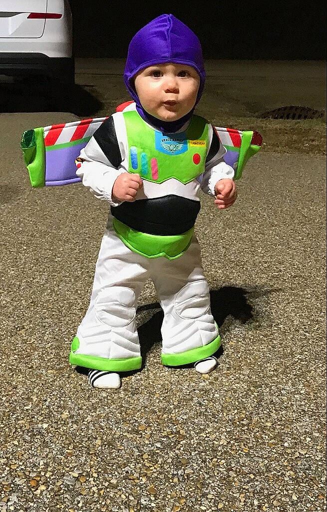 Desmond is registered to the contest to win money with this photo: baby, baby_toddler_clothing, cap, child, costume, fun, grass, happy, hat, headwear, hoodie, jacket, person, personal_protective_equipment, play, recreation, sitting, sleeve, sneakers, soil