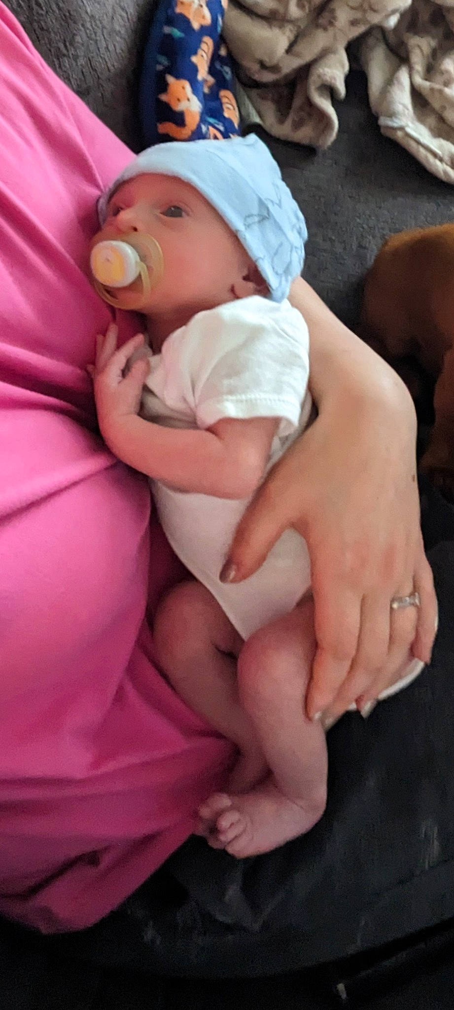 Elias joined the competition — help win amazing prizes! baby, baby_products, baby_toddler_clothing, child, comfort, finger, foot, gesture, happy, hat, headwear, human_leg, knee, lap, nail, person, pink, sitting, skin, thigh