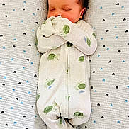 Connor is registered to the contest to win money with this photo: newborn, baby, sleeping, onesie, turtle_pattern, blanket, heart_pattern, infant, cozy, cute, peaceful, child, soft, resting, lying_down, indoors, portrait, small, adorable, comfortable