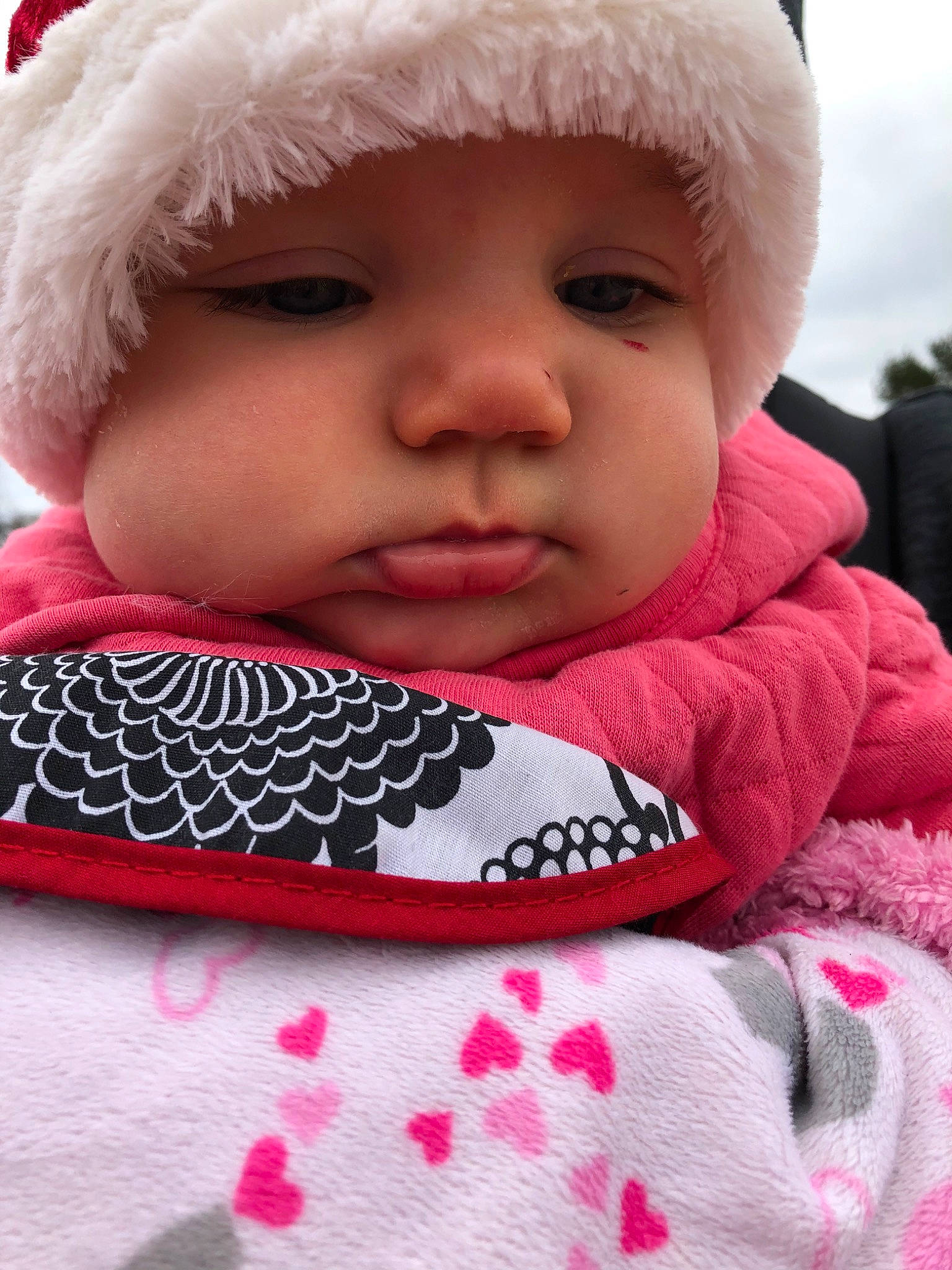 Taryn is registered to the contest to win money with this photo: baby, cheek, child, close_up, face, head, headgear, knit_cap, lip, mouth, nose, person, pink, skin, smile, toddler, winter, wool