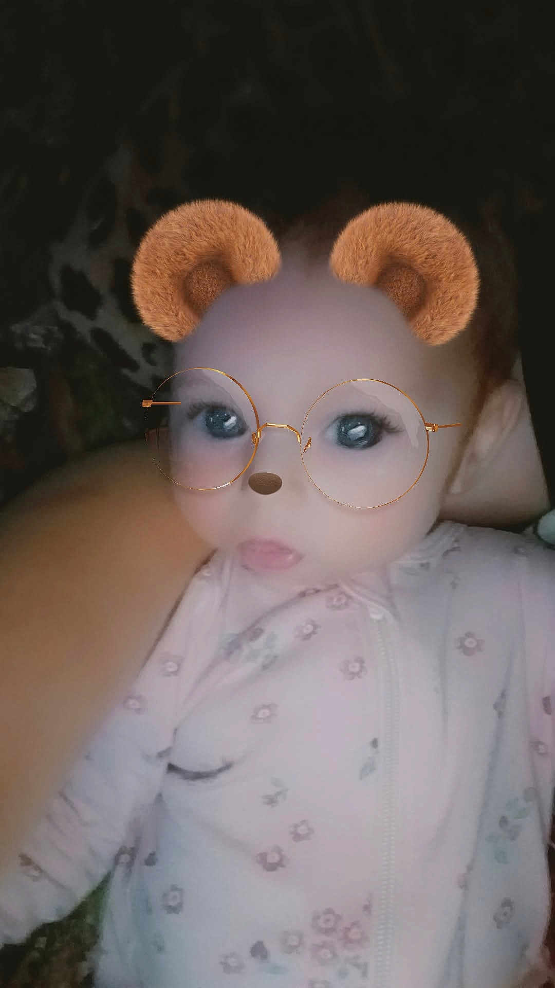 Oakley is registered to the contest to win money with this photo: baby, child, face_filter, bear_ears, glasses_filter, baby_clothing, onesie, floral_pattern, infant, portrait, cute, digital_filter, indoor, person, young_child, head_and_shoulders, closeup, soft_lighting, baby_girl, expression