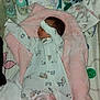 Oakley is registered to the contest to win money with this photo: baby, blanket, bottle, diaper, pacifier, crib, sleeping, onesie, infant, bed, soft_toy, baby_supplies, cute, child, resting, clothing, room, fabric, person, nursery
