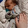 Oakley is registered to the contest to win money with this photo: baby, infant, pacifier, blanket, hand, onesie, sleepwear, cozy, cute, newborn, child, soft, resting, face, comfort, indoor, person, sleep, bed, toddler