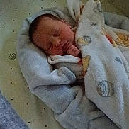 Oakley is registered to the contest to win money with this photo: newborn, baby, sleeping, blanket, crib, sheet, crown_pattern, cozy, infant, child, peaceful, wrapped, soft, indoors, resting, cute, face, hand, pacifier, toddler