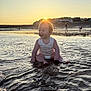 Teddy joined the competition — help win amazing prizes! baby, child, water, beach, sunset, sun, smile, sitting, ocean, sand, shore, reflection, people, sky, nature, outdoor, happy, infant, sunlight, play