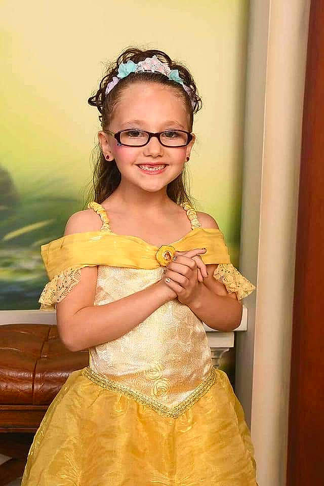 Giavonna joined the competition — help win amazing prizes! child, child_model, dress, fashion_accessory, formal_wear, gown, hair_accessory, headband, headpiece, joy, lady, long_hair, person, shoulder, smile, yellow