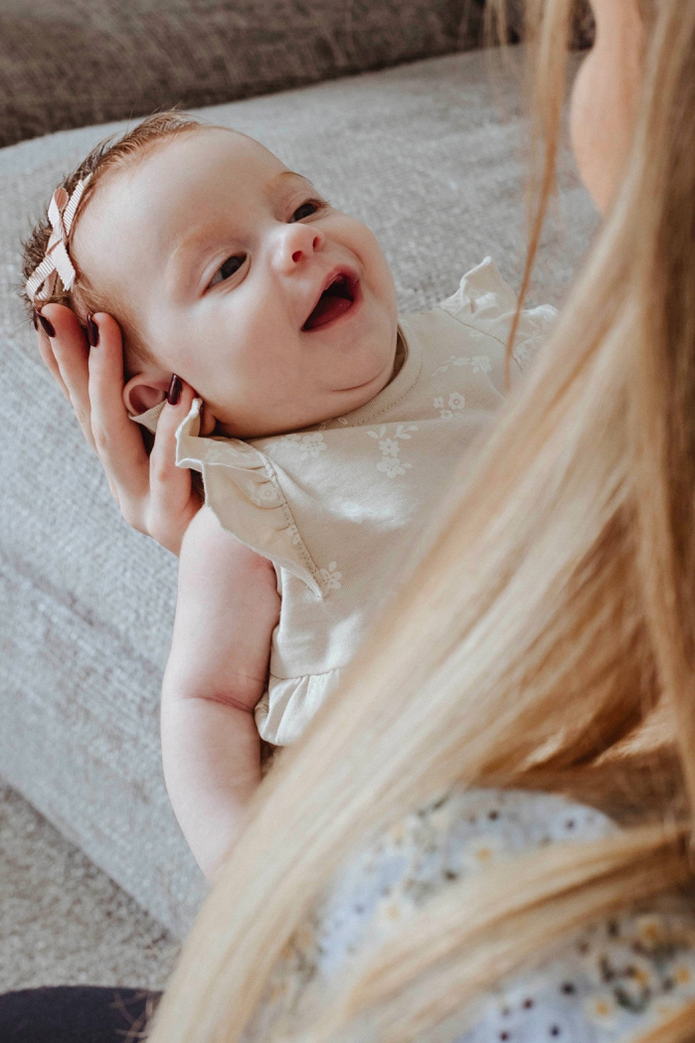 Darcie is registered to the contest to win money with this photo: arm, baby, baby_toddler_clothing, blond, child, comfort, companion_dog, eye, face, fashion_accessory, flash_photography, grass, happy, human_body, linens, lip, neck, person, skin, toddler