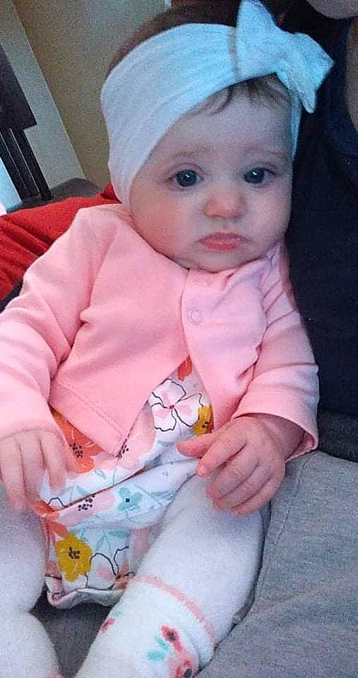 Stormy is registered to the contest to win money with this photo: baby, baby_toddler_clothing, beauty, cap, cheek, child, dress, eye, head, headwear, human_body, iris, lip, nose, organ, person, pink, skin, sleeve, textile