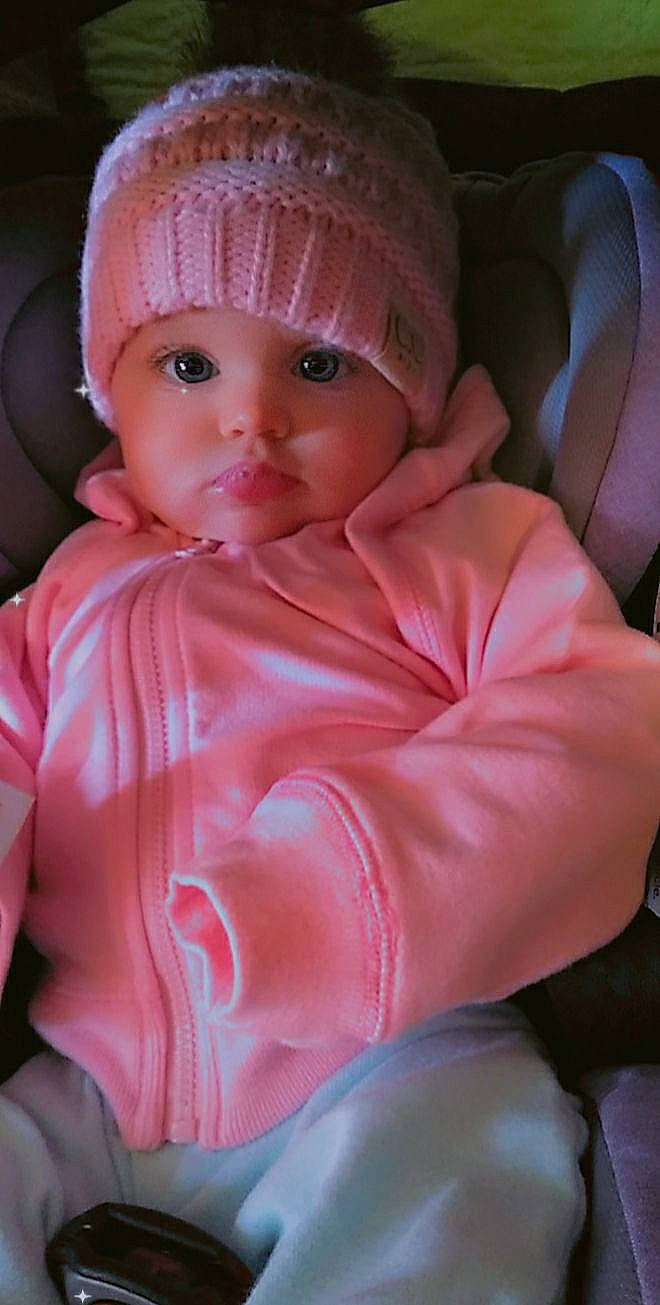 Stormy is registered to the contest to win money with this photo: baby, baby_toddler_clothing, cap, cheek, child, chin, comfort, eye, eyebrow, fashion_accessory, head, headwear, iris, knit_cap, lip, magenta, nose, person, pink, sleeve