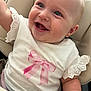 Evie joined the competition — help win amazing prizes! baby, child, smile, blue_eyes, white_shirt, pink_bow, lace, cushioned_seat, happy, cute, infant, portrait, closeup, human, skin, earrings, sitting, baby_clothes, expression, cheerful