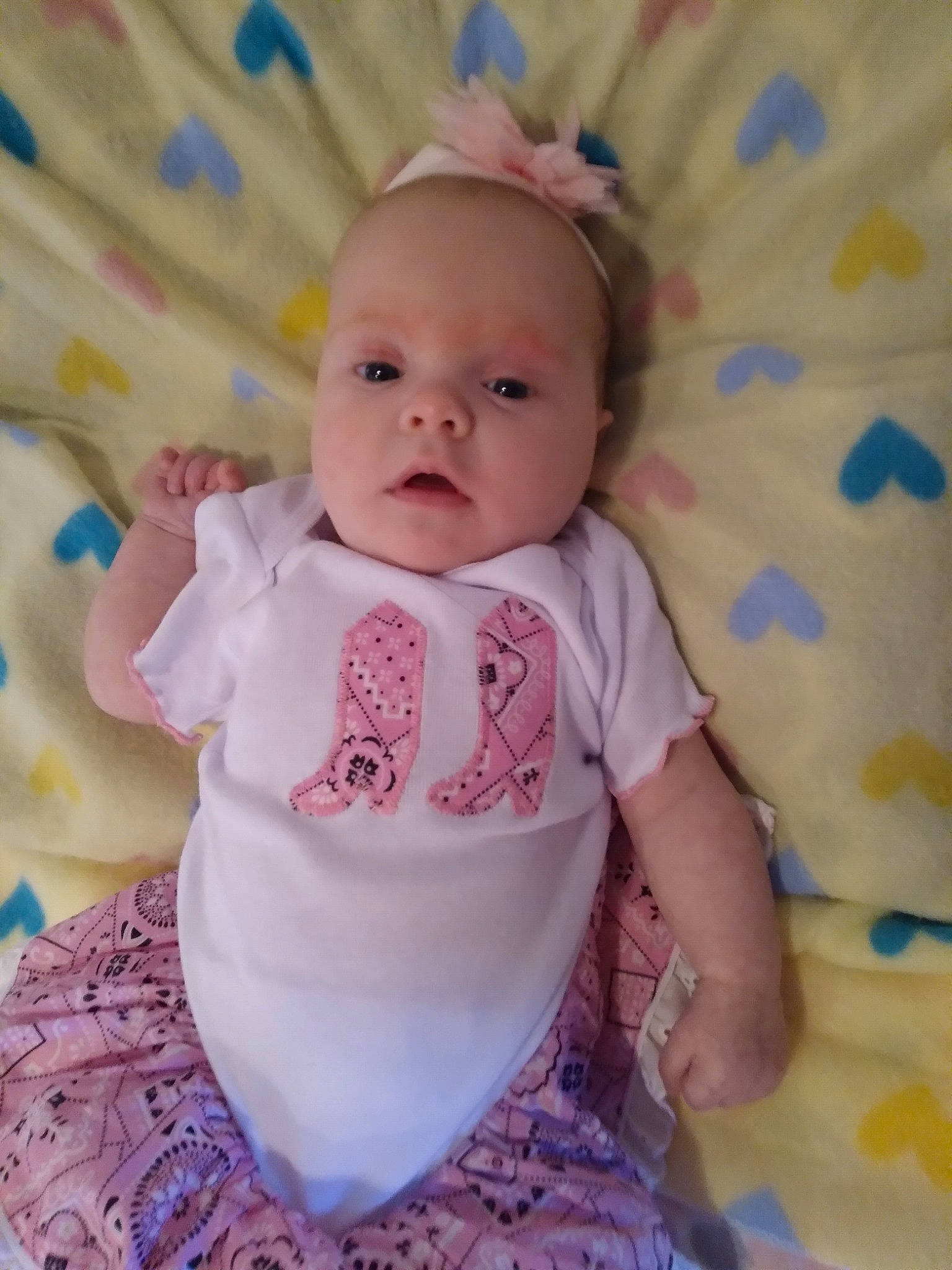 Mattie is registered to the contest to win money with this photo: baby, baby_products, baby_toddler_clothing, cheek, child, eye, happy, head, iris, magenta, pattern, person, pink, purple, skin, sleeve, smile, t_shirt, textile, toddler