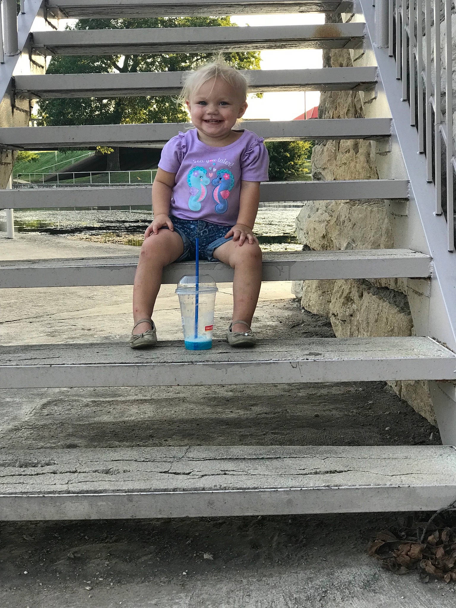 Sailor is registered to the contest to win money with this photo: boardwalk, child, fun, furniture, joy, leg, person, play, recreation, sitting, smile, stairs, summer, table, toddler, tree, vacation, walkway, wood