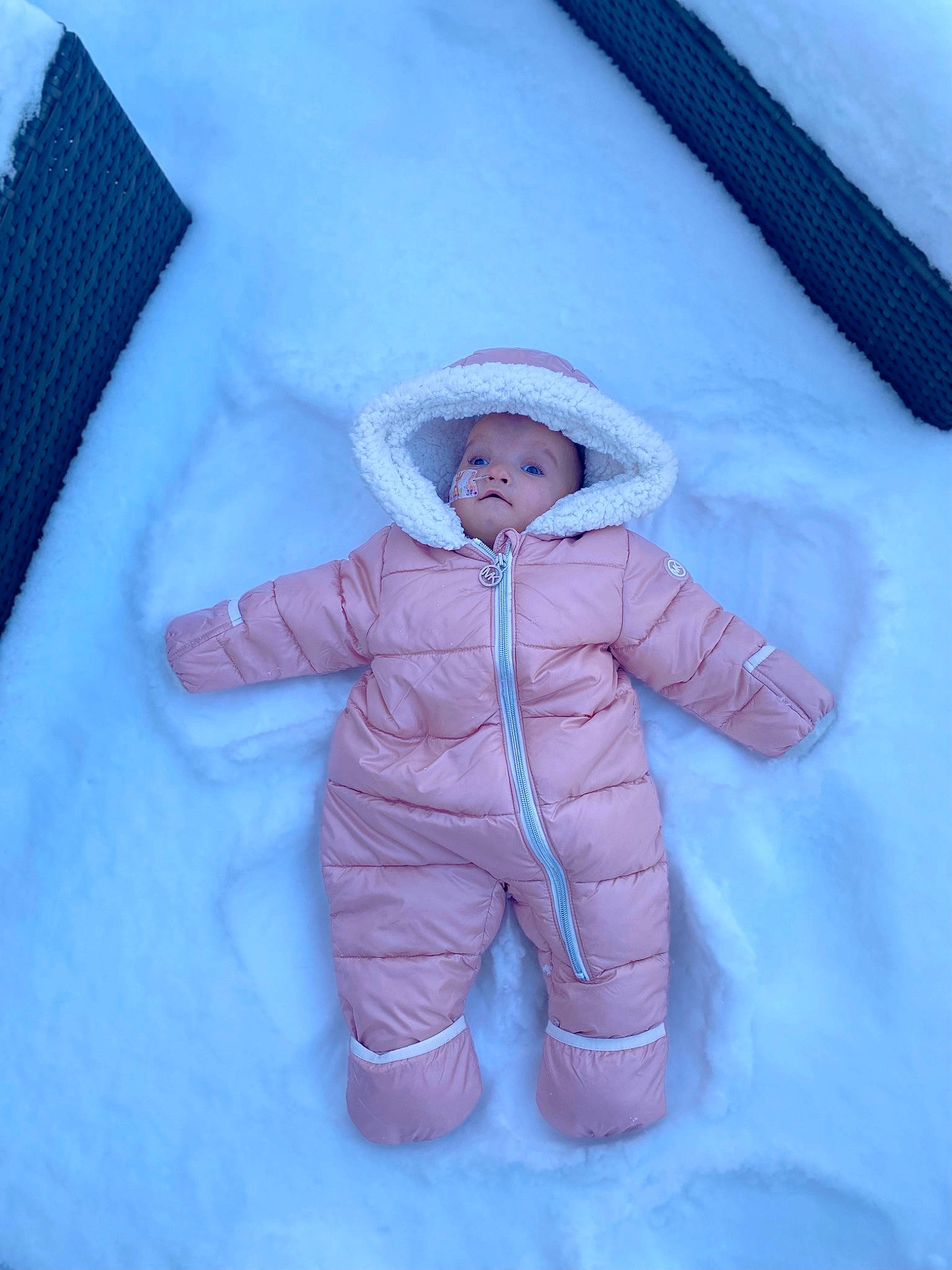 Charlotte is registered to the contest to win money with this photo: azure, baby, baby_sleeping, baby_toddler_clothing, child, comfort, electric_blue, face, freezing, fur, gesture, hat, linens, magenta, outerwear, pattern, person, sleeve, textile, toddler