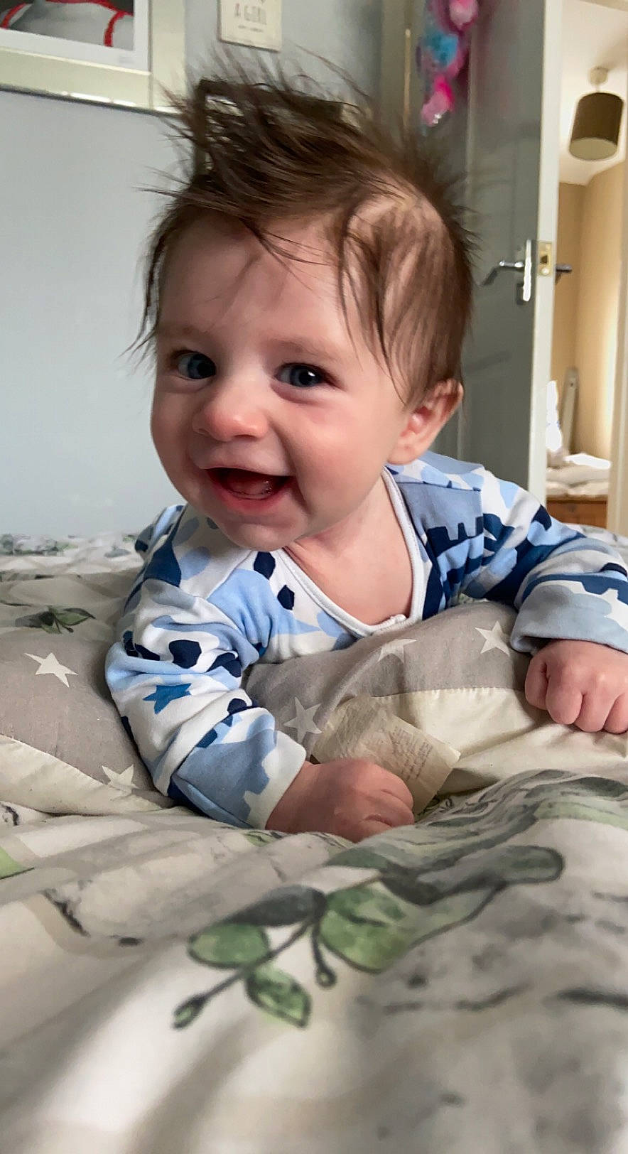 Parker joined the competition — help win amazing prizes! arm, baby, baby_toddler_clothing, cheek, child, comfort, eye, face, flooring, gesture, happy, head, linens, pattern, person, room, sitting, skin, sleeve, smile