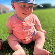 Dawson is registered to the contest to win money with this photo: baby, child, grass, outdoor, cap, hat, onesie, barefoot, cute, sitting, sunlight, greenery, summer, portrait, infant, happy, nature, casual, playful, daytime