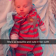 Ava is registered to the contest to win money with this photo: baby, newborn, infant, blanket, clothing, striped_outfit, lying_down, bed, soft_fabric, pink_heart, date_sticker, text_overlay, cute, sleepy, portrait, child, cozy, indoors, person, young