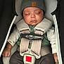 baby, sleeping, car_seat, hat, clothing, infant, child, straps, safety_belt, cute, peaceful, hands, face, headwear, soft, warm, resting, newborn, portrait, cozy