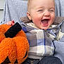 baby, child, smiling, laughing, plaid_jacket, pumpkin, toy, fall, halloween, cozy, cute, happy, infant, outdoor, clothing, person, seat, fabric, head, portrait