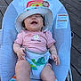 Mia is registered to the contest to win money with this photo: baby, child, smiling, laughing, hat, pink_clothing, turtle, baby_bouncer, outdoor, wooden_deck, sun_hat, infant, happy, cute, person, seat, colorful, playful, summer, sunny