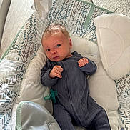 John Iv joined the competition — help win amazing prizes! baby, infant, onesie, pacifier, baby_seat, cushion, soft_toy, patterned, blue_clothing, indoor, child, newborn, face, hand, footed_pajamas, comfort, relaxing, curious, portrait, cozy